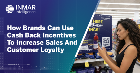 Shopper scans a QR code on an in-store display for cash back incentives beside a retail shelf with packaged goods and promotional signage